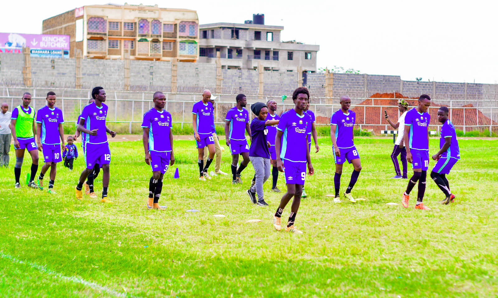 A Thika youth football team Maina supports, warming up before a match